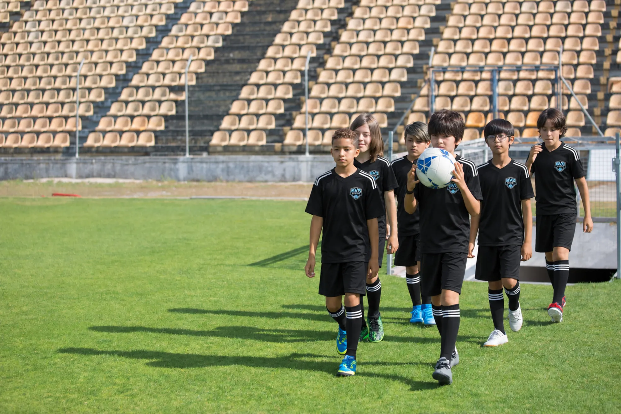 The team walking onto the field together after training